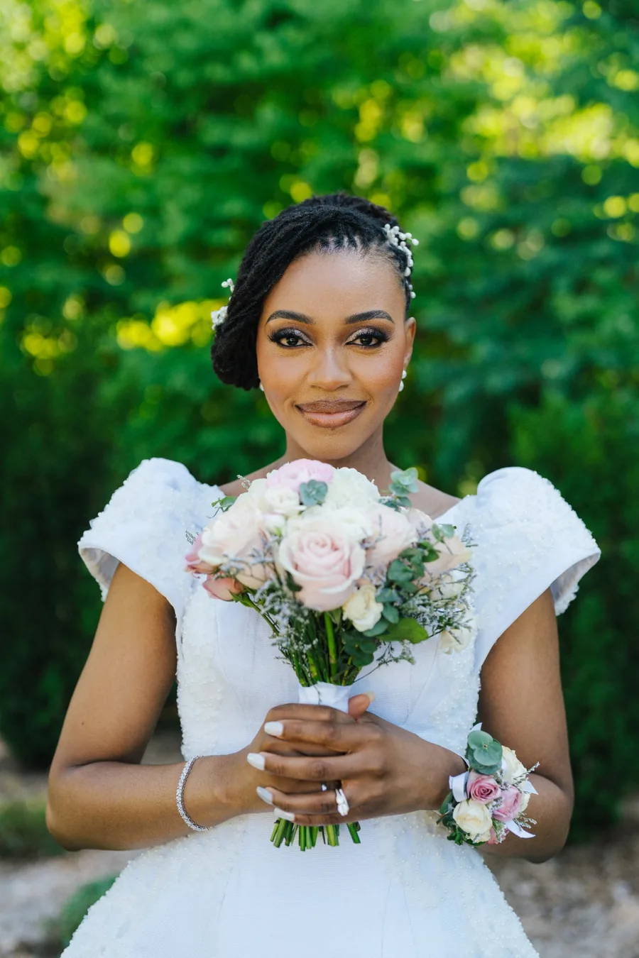Bride holding a pink rose bouquet in a white off-shoulder gown outdoors — bridal portrait wedding photography Niagara Region by Captivate Photo+Cinema