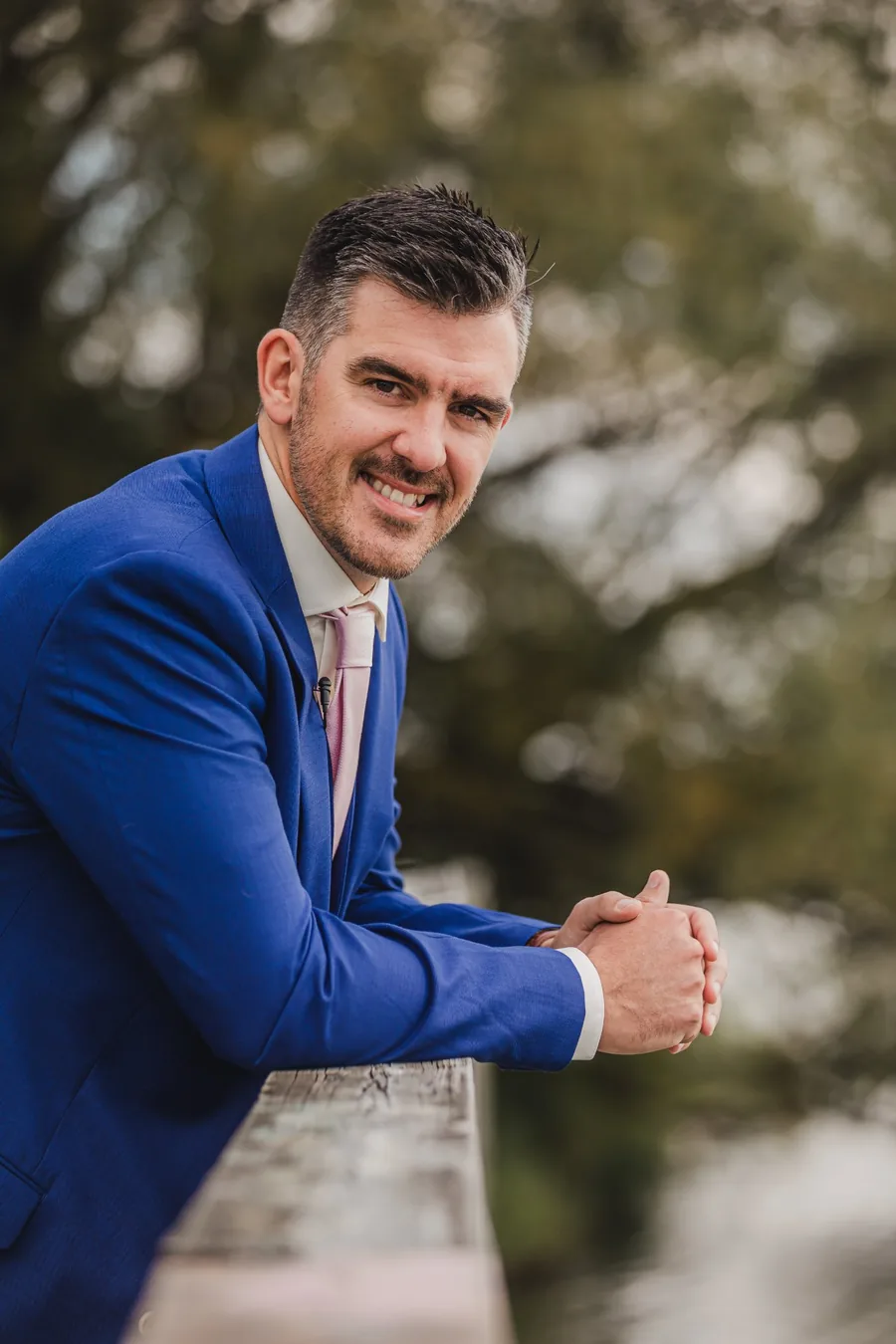 Groom in blue suit smiling outdoors during wedding portraits — wedding photography St. Catharines Ontario by Captivate Photo+Cinema